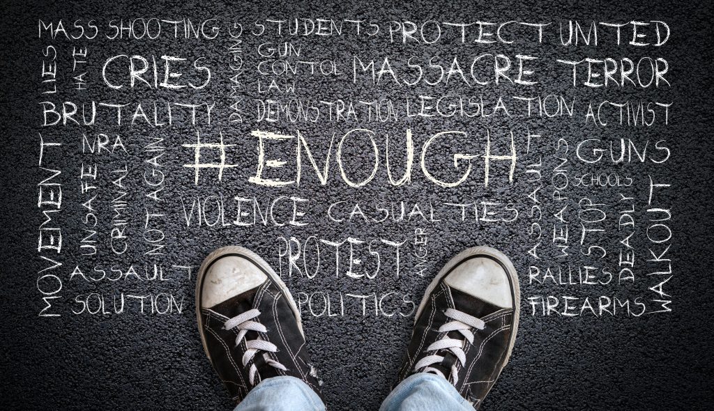 Teen Wearing Canvas Shoes on Asphalt With # Enough Word Cloud
